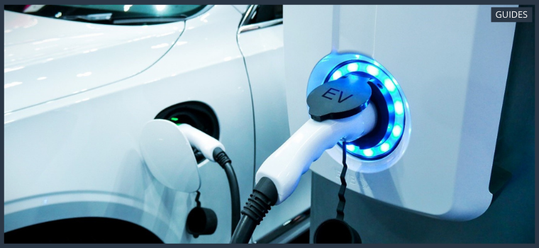 Electric vehicle recharges its battery by plugging into EV charging point.