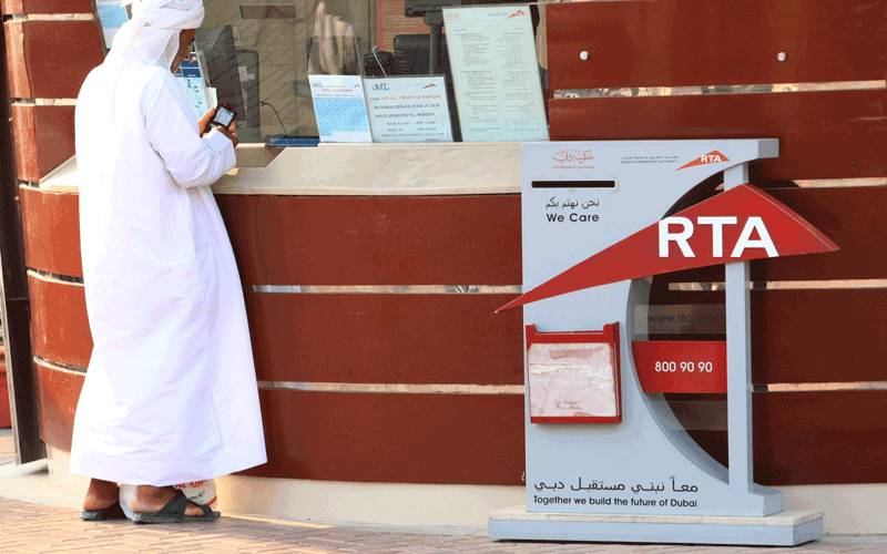 Import vehicle into the UAE, a man insures and registers his imported vehicle at the UAE’s Road and Transport Authority (RTA)