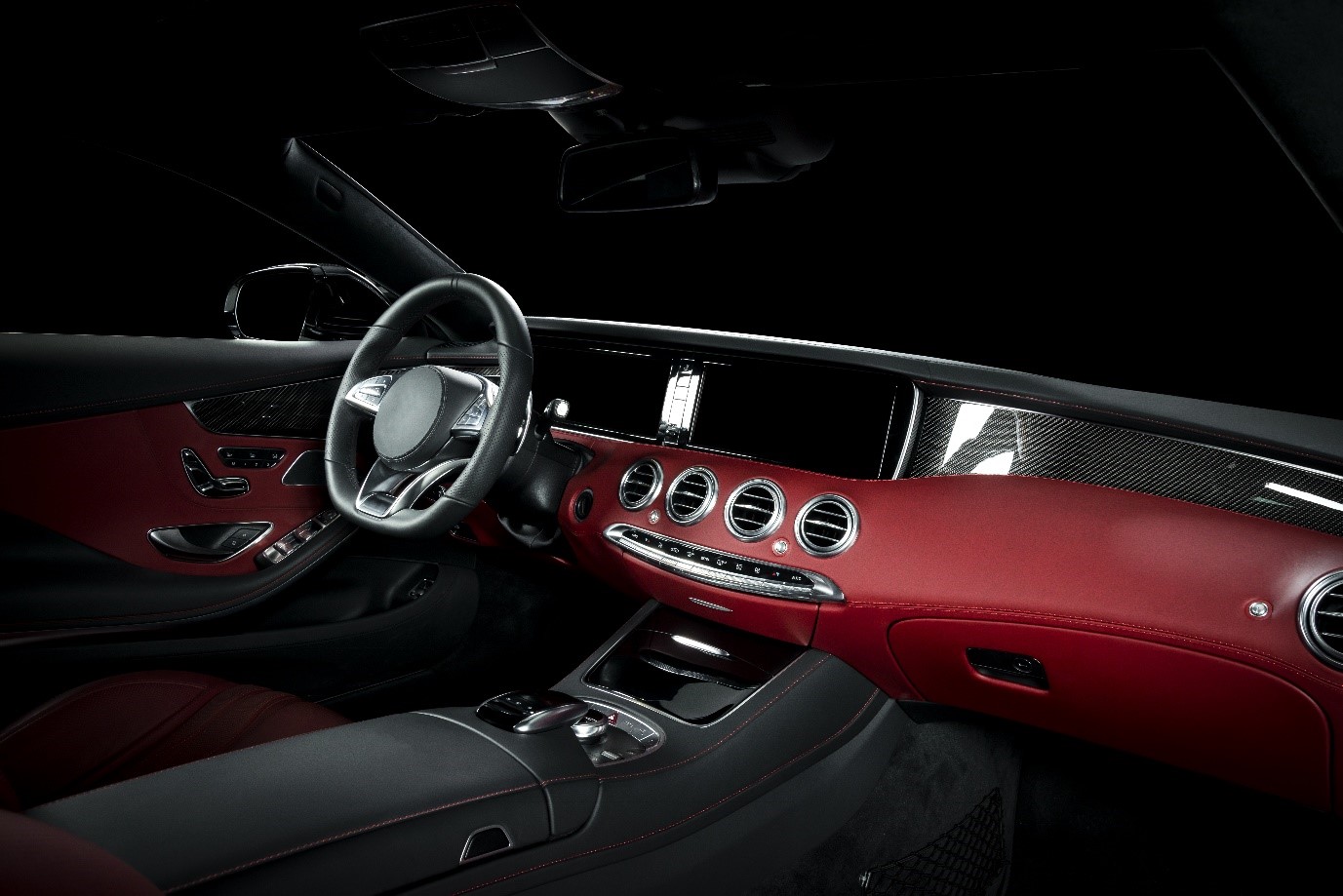 How to change car interior color: a red luxury car interior including steering wheel, shift lever and dashboard. 