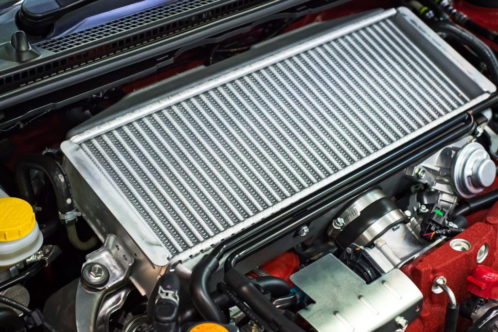 The difference between GCC specs and American specs can be compared by opening the car bonnet to expose inner car parts including the radiator