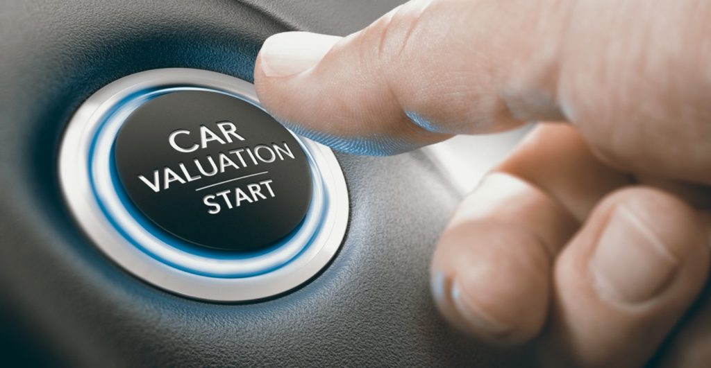 how much is your car worth in UAE; a man presses a button to check car value and start a car valuation
