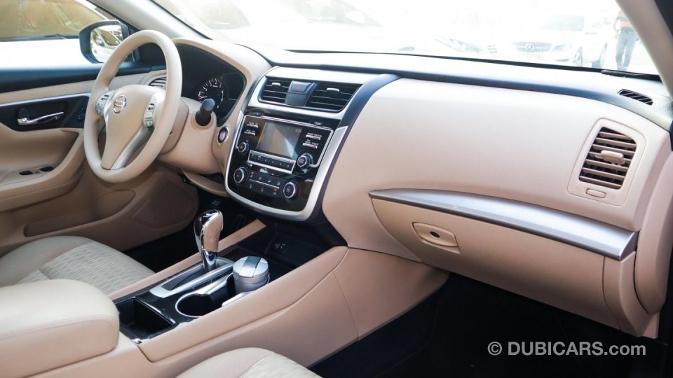 View of the front interior of a grey Nissan Altima for sale in Dubai, showcasing how to sell a car in Dubai on the internet with high-quality photographs detailing different elements of the vehicle for sale.