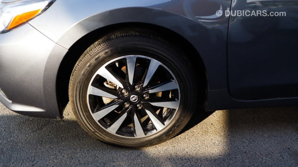 Wheel shot of the front wheel of a grey Nissan Altima for sale in Dubai; an example of how to sell a car in Dubai on the internet as a private seller using high-quality photography to show the vehicle in detail.